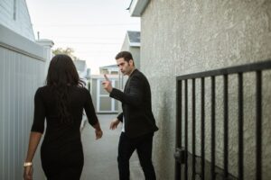 A couple having a tense argument in an outdoor alley, showcasing relationship conflict.